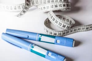 Ozempic pen and measuring tape