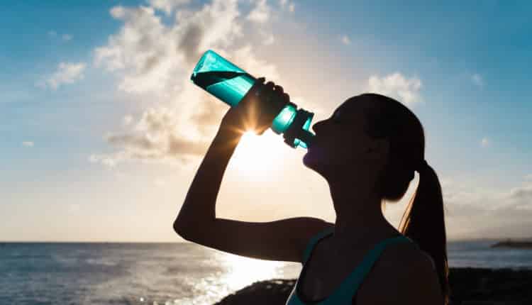 Woman drinking water during workout